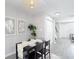 Charming dining room featuring a modern light fixture, plant, and stylish table set for four at 14611 Pine Glen Cir, Lutz, FL 33559
