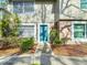 Charming condo featuring a well-maintained front exterior with neat landscaping and a freshly painted door at 14611 Pine Glen Cir, Lutz, FL 33559
