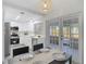 Modern kitchen featuring stainless steel appliances, sleek cabinetry, and access to an outdoor patio at 14611 Pine Glen Cir, Lutz, FL 33559