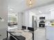 Open-concept kitchen featuring stainless steel appliances, sleek cabinetry, and seamless connection to the living area at 14611 Pine Glen Cir, Lutz, FL 33559