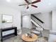 Comfortable seating in living room, complete with updated floors and a staircase at 14611 Pine Glen Cir, Lutz, FL 33559