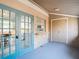 Covered patio features blue painted floors and a pass-through window to the kitchen at 14611 Pine Glen Cir, Lutz, FL 33559