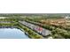 Beautiful aerial shot showcasing townhome community nestled on lake front property surrounded by mature trees at 14648 Bournemouth Rd, Tampa, FL 33626