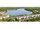 Picturesque aerial view highlighting community of townhomes located near a large lake at 14648 Bournemouth Rd, Tampa, FL 33626