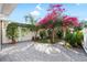 Beautiful backyard featuring stone patio and lush greenery, accented by vibrant flowers and decorative trees at 14648 Bournemouth Rd, Tampa, FL 33626