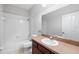 Functional bathroom with a shower-tub combination, neutral decor, and a well-lit vanity area at 14648 Bournemouth Rd, Tampa, FL 33626