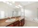 Bathroom featuring a dual sink vanity, large mirror, bathtub, and shower at 14648 Bournemouth Rd, Tampa, FL 33626