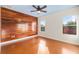 Bedroom featuring hardwood floors, light blue ceiling, and wood paneling on one wall at 14648 Bournemouth Rd, Tampa, FL 33626