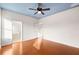 Bedroom with blue ceiling, hardwood floors and access to bathroom and closets at 14648 Bournemouth Rd, Tampa, FL 33626