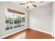 Bedroom with hardwood floors and a large window offering lake views; ceiling fan and neutral colors at 14648 Bournemouth Rd, Tampa, FL 33626