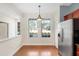 Bright dining area with large windows and stainless steel refrigerator at 14648 Bournemouth Rd, Tampa, FL 33626
