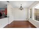 Open dining room with hardwood floors, windows, and an ornate chandelier at 14648 Bournemouth Rd, Tampa, FL 33626
