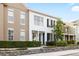 Inviting townhome showcasing classic design, complemented by lush greenery and a neatly landscaped yard at 14648 Bournemouth Rd, Tampa, FL 33626