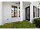 Inviting front porch with black door and large windows offering water views at 14648 Bournemouth Rd, Tampa, FL 33626