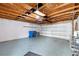 Spacious garage with an automatic door, ample storage and blue and black trash receptacles at 14648 Bournemouth Rd, Tampa, FL 33626