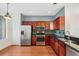 Well-appointed kitchen with stainless steel appliances and dark wood cabinets at 14648 Bournemouth Rd, Tampa, FL 33626