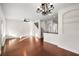 Open-concept living room with hardwood floors adjacent to the kitchen and staircase at 14648 Bournemouth Rd, Tampa, FL 33626