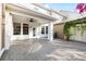 Covered outdoor patio featuring brick floors, a ceiling fan, and elegant curtains for added privacy and style at 14648 Bournemouth Rd, Tampa, FL 33626