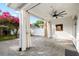 Covered patio with brick floors, neutral tones, white posts and curtains, and fan at 14648 Bournemouth Rd, Tampa, FL 33626