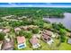 An aerial view of a lovely home in a lush, upscale neighborhood nestled near a tranquil lake surrounded by dense trees at 14910 Tom Fazio Ct, Tampa, FL 33626