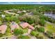 Aerial shot of luxury home, pool, and picturesque neighborhood with lake views at 14910 Tom Fazio Ct, Tampa, FL 33626