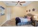 Cozy bedroom with a ceiling fan, comfortable bed, and tasteful decor at 14910 Tom Fazio Ct, Tampa, FL 33626