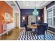 Elegant dining room with a round table, blue chairs, and a striking blue chandelier at 14910 Tom Fazio Ct, Tampa, FL 33626