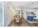 Inviting dining area with modern chandelier and an open view to the kitchen at 14910 Tom Fazio Ct, Tampa, FL 33626