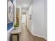 Bright hallway featuring stylish tile flooring and decorative accents, leading to various rooms at 14910 Tom Fazio Ct, Tampa, FL 33626