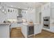Bright kitchen boasts custom white cabinetry, stainless steel appliances, and an island with a wine refrigerator at 14910 Tom Fazio Ct, Tampa, FL 33626