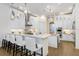 Open concept kitchen with white cabinets, stainless appliances, and an island with seating for casual dining at 14910 Tom Fazio Ct, Tampa, FL 33626