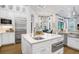 Open kitchen with white cabinets, stainless steel appliances, and a large center island at 14910 Tom Fazio Ct, Tampa, FL 33626