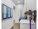 Convenient laundry room with blue washer and dryer, utility sink, and ample storage cabinets at 14910 Tom Fazio Ct, Tampa, FL 33626