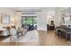 Bright living room featuring a neutral color palette, hardwood floors, and sliding glass doors at 14910 Tom Fazio Ct, Tampa, FL 33626