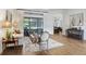 Bright living room with hardwood floors, comfortable seating, and access to the outdoor patio at 14910 Tom Fazio Ct, Tampa, FL 33626