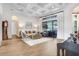 Open living space with coffered ceilings, neutral furniture, wood floors and grand piano at 14910 Tom Fazio Ct, Tampa, FL 33626