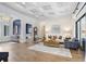 Spacious living room with a coffered ceiling, hardwood floors, and neutral furniture at 14910 Tom Fazio Ct, Tampa, FL 33626