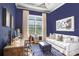 Cozy home office with blue walls, white trim, and a large window for natural light at 14910 Tom Fazio Ct, Tampa, FL 33626
