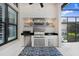This outdoor kitchen features stainless steel appliances, a grill, a sink, and stylish decor at 14910 Tom Fazio Ct, Tampa, FL 33626