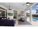 Elegant outdoor living area with a dining space, comfortable seating, and a view of the pool at 14910 Tom Fazio Ct, Tampa, FL 33626
