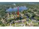 Aerial view of waterfront home with mature trees and water access at 18712 Lakeshore Dr, Lutz, FL 33549