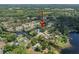 Wide aerial view showcases waterway homes in a lush, green landscape at 18712 Lakeshore Dr, Lutz, FL 33549