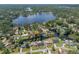 Expansive aerial view of lakefront community with lush greenery and waterfront homes at 18712 Lakeshore Dr, Lutz, FL 33549