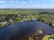 Expansive aerial view of the lakefront community, highlighting the peaceful and scenic waterfront location at 18712 Lakeshore Dr, Lutz, FL 33549