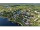 Aerial view showcasing the neighborhood, lush greenery, and picturesque waterways at 18712 Lakeshore Dr, Lutz, FL 33549