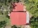 Aerial view of the home highlighting a red roof and surrounding trees at 18712 Lakeshore Dr, Lutz, FL 33549