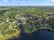 Aerial view of neighborhood and waterways surrounded by lush greenery at 18712 Lakeshore Dr, Lutz, FL 33549