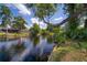Picturesque canal view surrounded by lush trees and landscaping, emphasizing natural beauty at 18712 Lakeshore Dr, Lutz, FL 33549