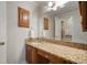 Bathroom with a vanity and granite countertop with cabinets and a large mirror at 18712 Lakeshore Dr, Lutz, FL 33549
