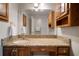 Bathroom with a vanity and granite countertop with cabinets and a large mirror at 18712 Lakeshore Dr, Lutz, FL 33549